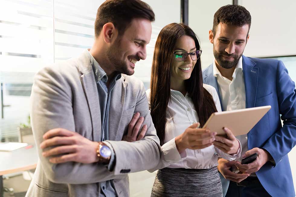 Businessmen and businesswoman using digital tablet