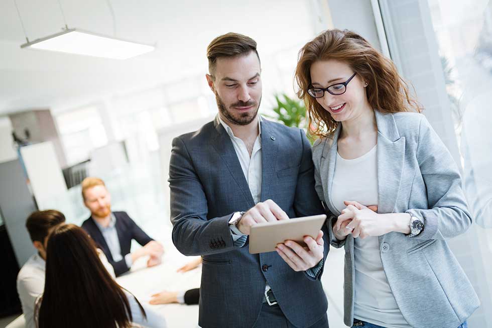 Cheerful coworkers in office during company meeting